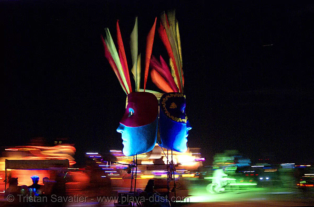 art car with big blue masked faces - burning man 2007, blue faces, burning man car, burning man festival, mark sheets, masks, night