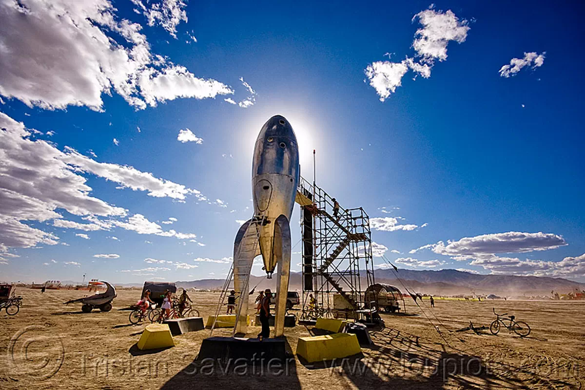 the raygun gothic rocket - burning man 2009, art installation, backlight, burning man festival, clouds, launch pad, raygun rocket, space ship