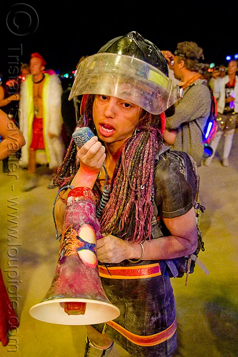 firefighter woman with bullhorn - burning man 2009, burning man festival, night, sara, stock photo