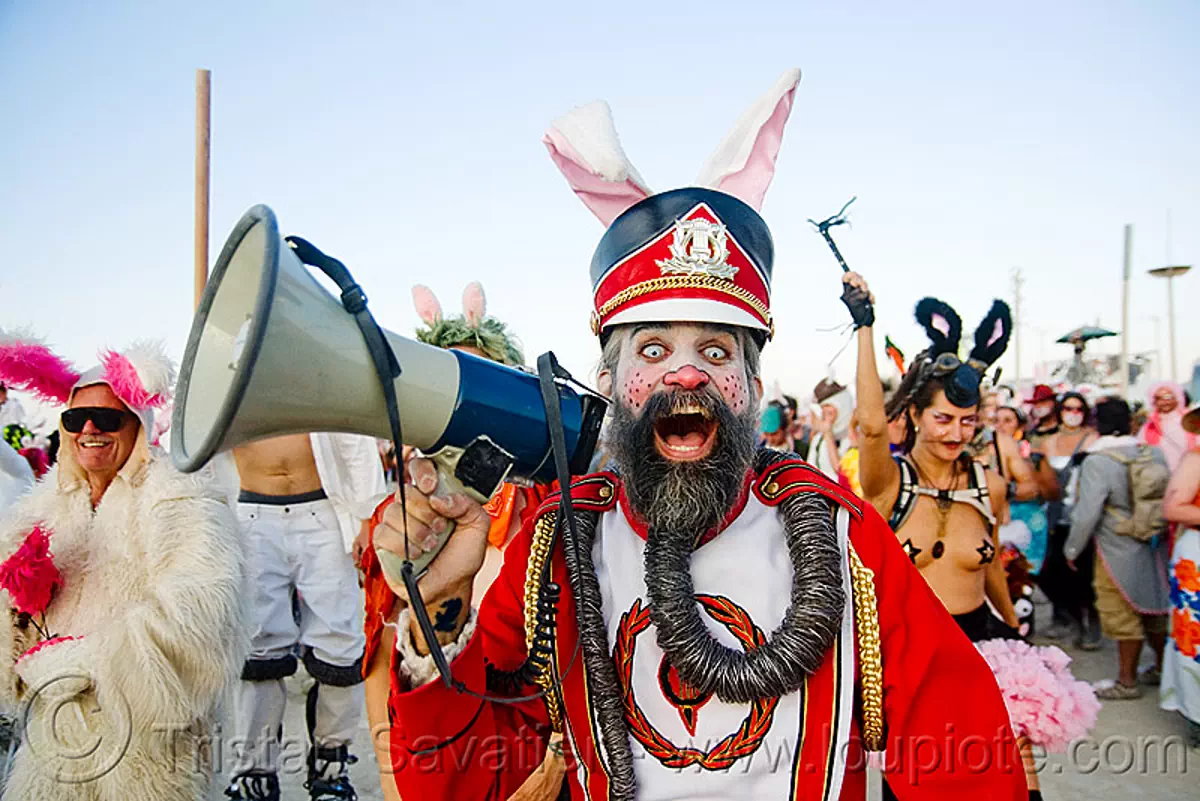 steven raspa is the uber bunny, leading the bunny march - burning man 2009, beard, bullhorn, bunnies, bunny ears, burning man festival, cap, color contact lenses, contacts, costume, hat, makeup, red, special effects contact lenses, theatrical contact lenses, stock photo