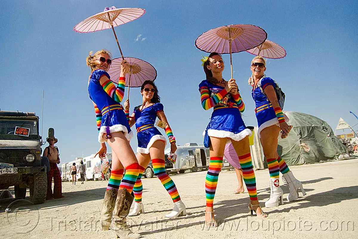 the rainbow brite's - girls with rainbow tights and japanese umbrellas - burning man 2009, burning man festival, cosplay, rainbow brites, rainbow colors, rainbow stockings, women, stock photo