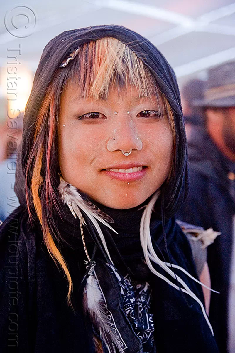 dusty asian woman at center camp cafe - burning man 2009, bridge piercing, burning man festival, karl, nose piercing, septum piercing, stock photo