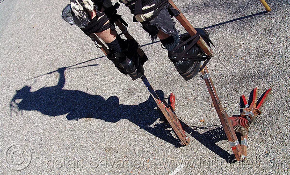 bird-feet iron stilts - burning man decompression 2005 (san francisco), metal, shadow, stiltwalker, stiltwalking, stock photo