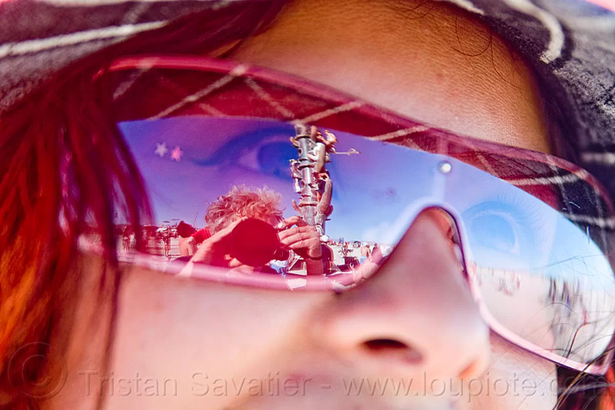 reflexion of the tower in a woman's sunglasses, burning man festival, reflection, the minaret, stock photo