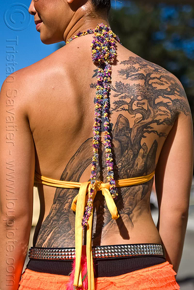 woman with back tattoo - japanese etching style, back piece, burning man decompression, garden tattoo, jane, tattooed, stock photo