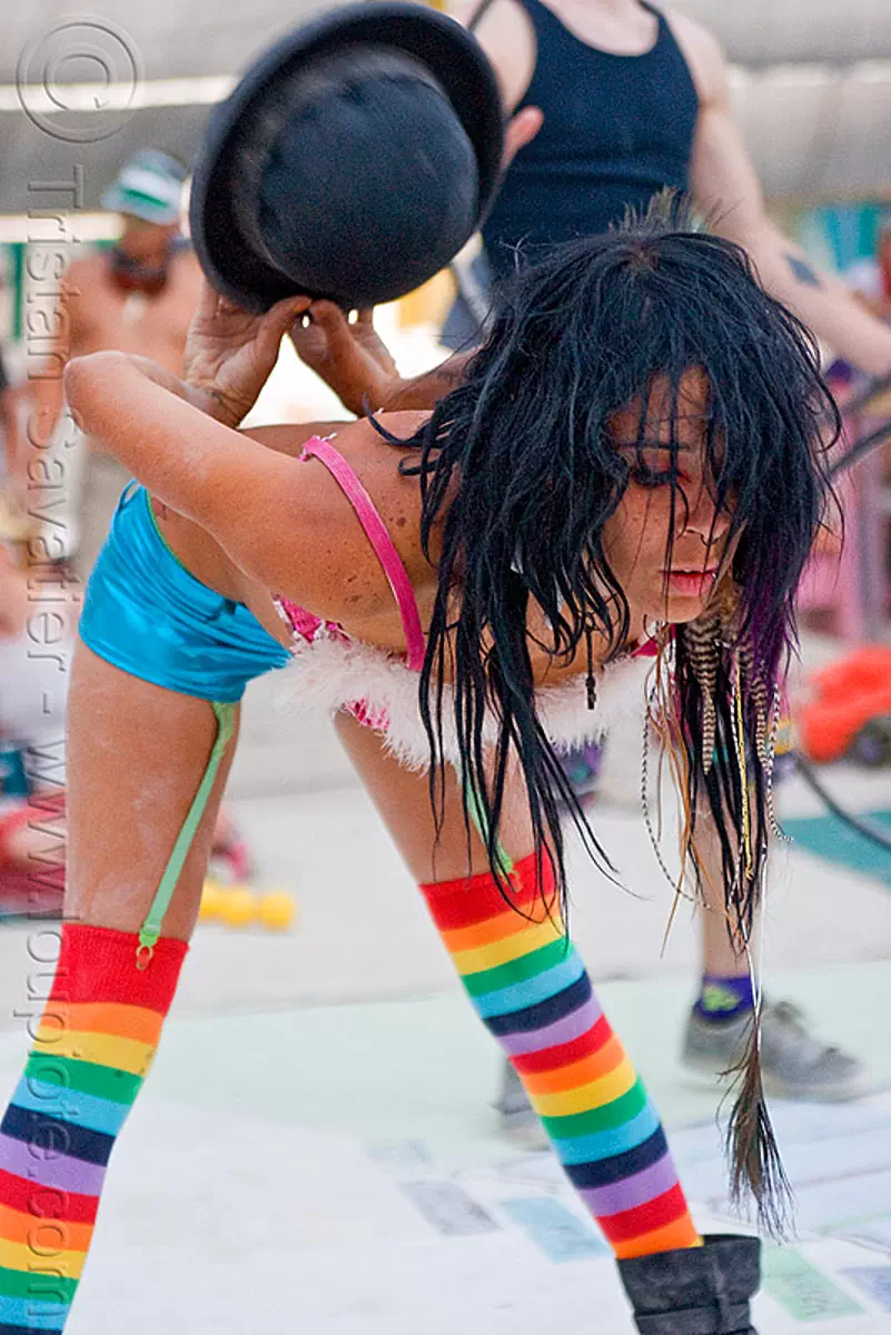 dancing with a bowler hat - mumu, burning man festival, center camp, performance, rainbow colors, rainbow stockings, rainbow tights