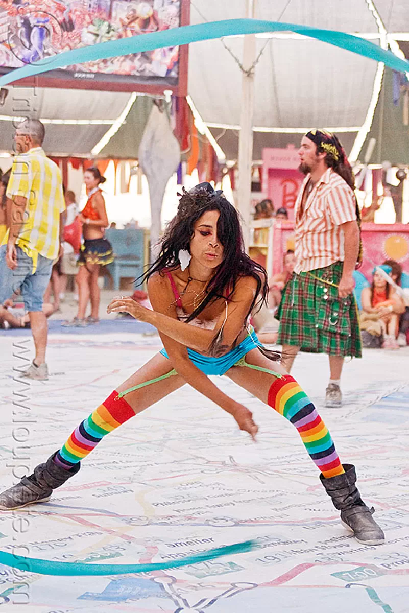 flowing ribbon artist - mumu, blue ribbon, burning man festival, center camp, performance, rainbow colors, rainbow stockings, rainbow tights, stock photo