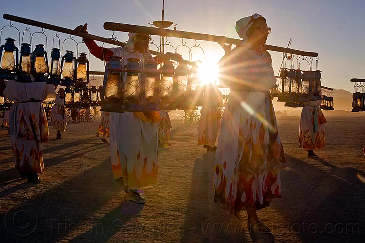 lamplighters at sunset - burning man 2012, backlight, burning man festival, dawn, lamp lighters, lens flare, petrol lamps, sun, stock photo