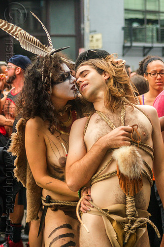 couple kissing - tribal fetish costume, body paint, body painting, costume, feathers, fetish, kissing, lovers, makeup, man, necklace, rope bondage, topless, tribal, woman