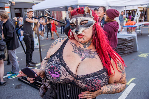 woman with chest tattoo and fox mask - folsom street fair 2015 (san francisco), arm tattoos, chest tattoo, chin tattoo, fox mask, masked, red hair, unicorn tattoo, woman