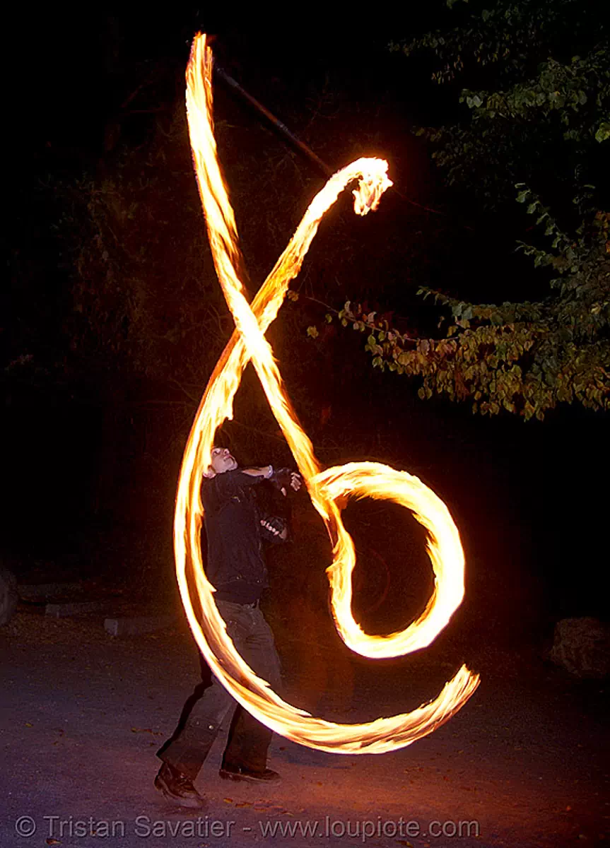 rico spinning fire staff (san francisco), fire dancer, fire dancing, fire performer, fire spinning, flame, long exposure, night, stock photo
