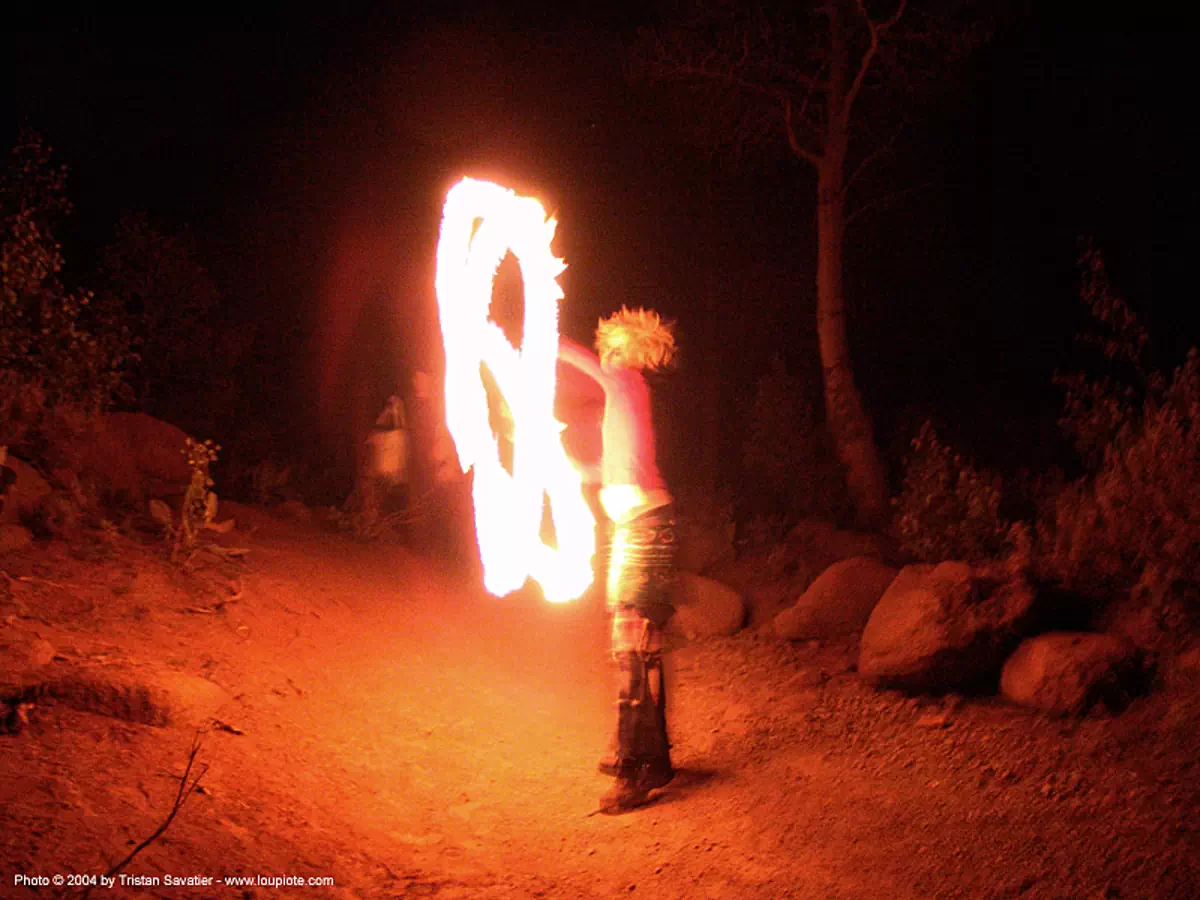 fire-dancer - rainbow gathering - hippie, fire dancer, fire dancing, fire performer, fire poi, fire spinning, flame, long exposure, night, rainbow family, spinning fire, stock photo