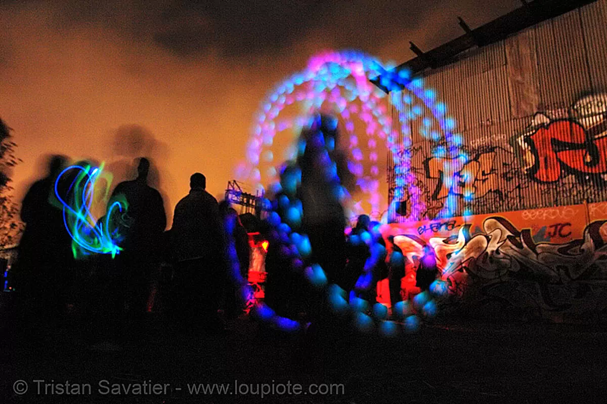 laura spinning oggz at tire beach (san francisco), glow, graffiti, industrial, led lights, light poi, long exposure, night, rave lights, spinning light, toxic beach, warehouse, stock photo