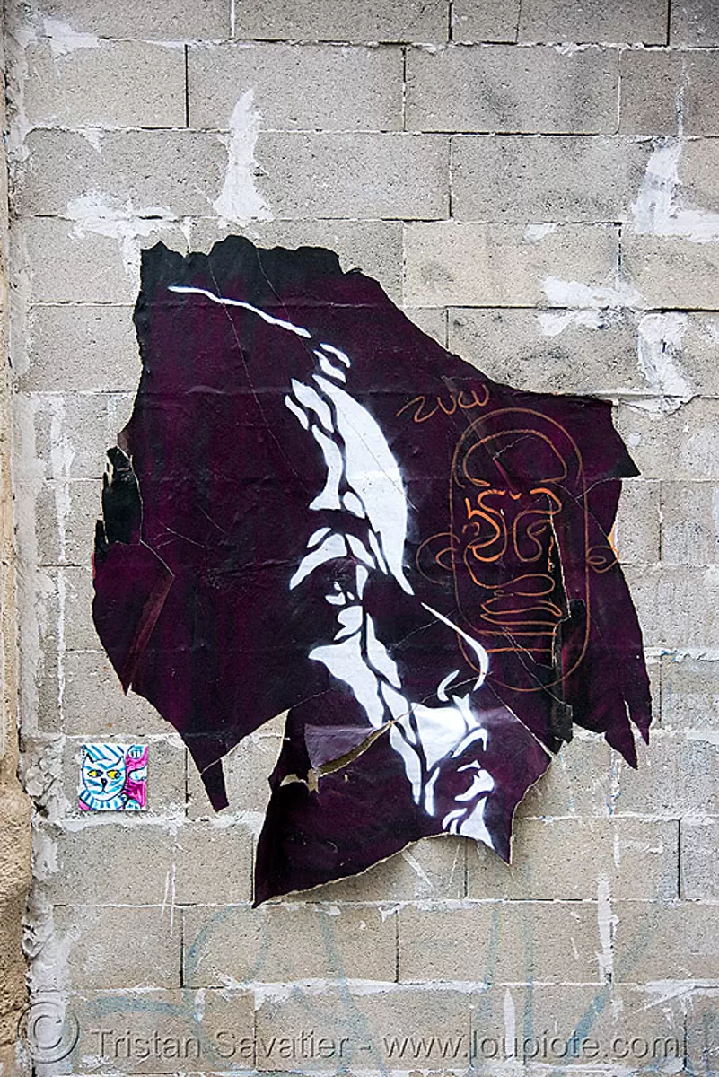 stencil graffiti poster on cinder blocks wall (paris), concrete, street art, stock photo