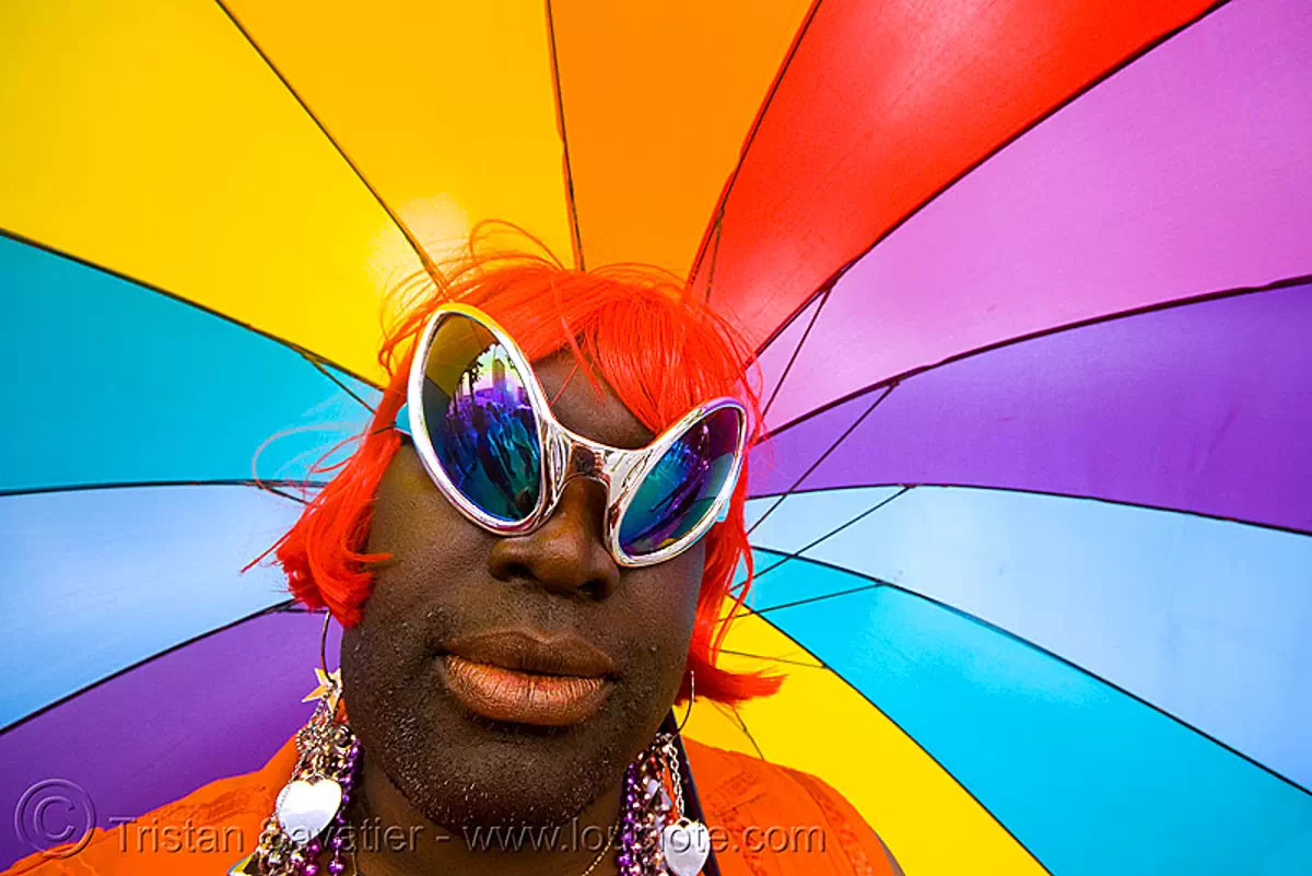 rainbow umbrella, african american man, alien sunglasses, crossdressing, drag queen, earrings, gay pride 2008, gay pride festival, rainbow colors, red wig, sf gay pride, transvestite