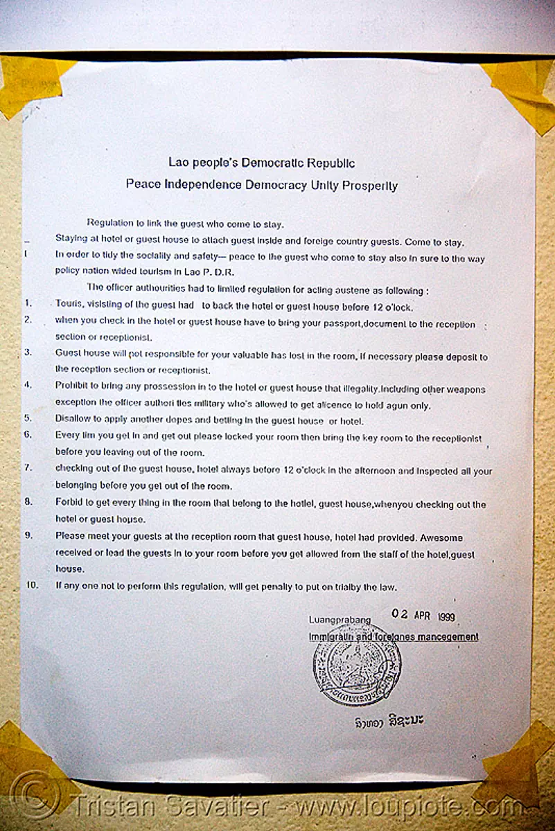 hotel notice showing midnight curfew law - luang prabang (laos)
