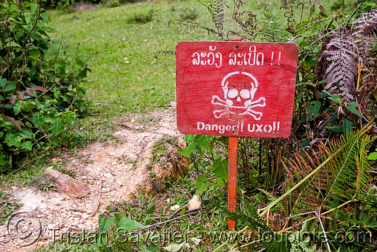 UXO LAO - unexploded ordnance (bombs from the vietnam war) - laos, bomb disposal, cross, crossbones, danger, explosive, landmine, lao national unexploded ordnance programme, military, red, safety sign, skull and bones, skull n bones, unexploded bombs, stock photo
