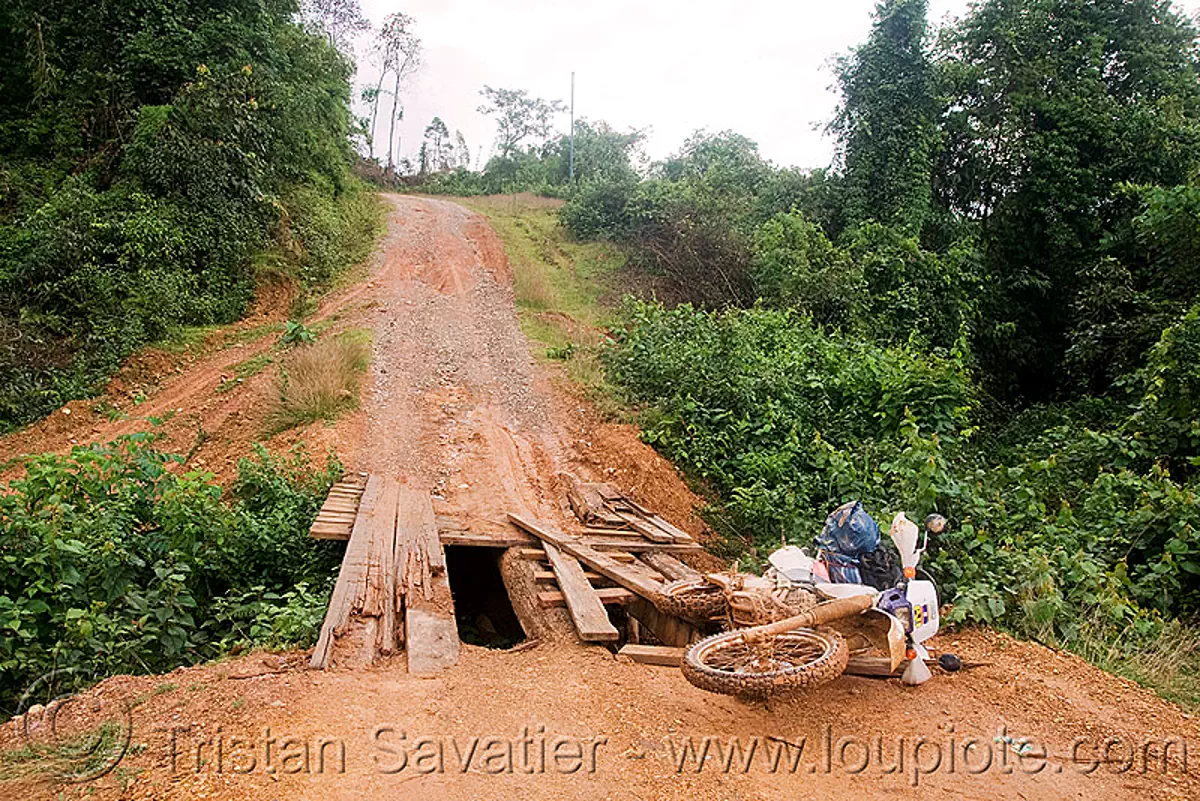 honda XR 250 - motorcycle accident on broken bridge  (laos), 250cc, crash, dirt road, down, honda motorcycle, motorbike, touring, traffic accident, unpaved, stock photo