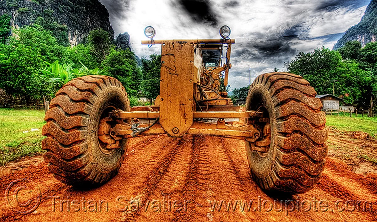 caterpillar CAT 14G (140G) grader - road construction (laos), cat grader, caterpillar 140g, caterpillar 14g road grader, caterpillar road grader, engine, groundworks, heavy equipment, hydraulic, machinery, motor grader, mud tires, preparation, roadworks, wheels, yellow, stock photo