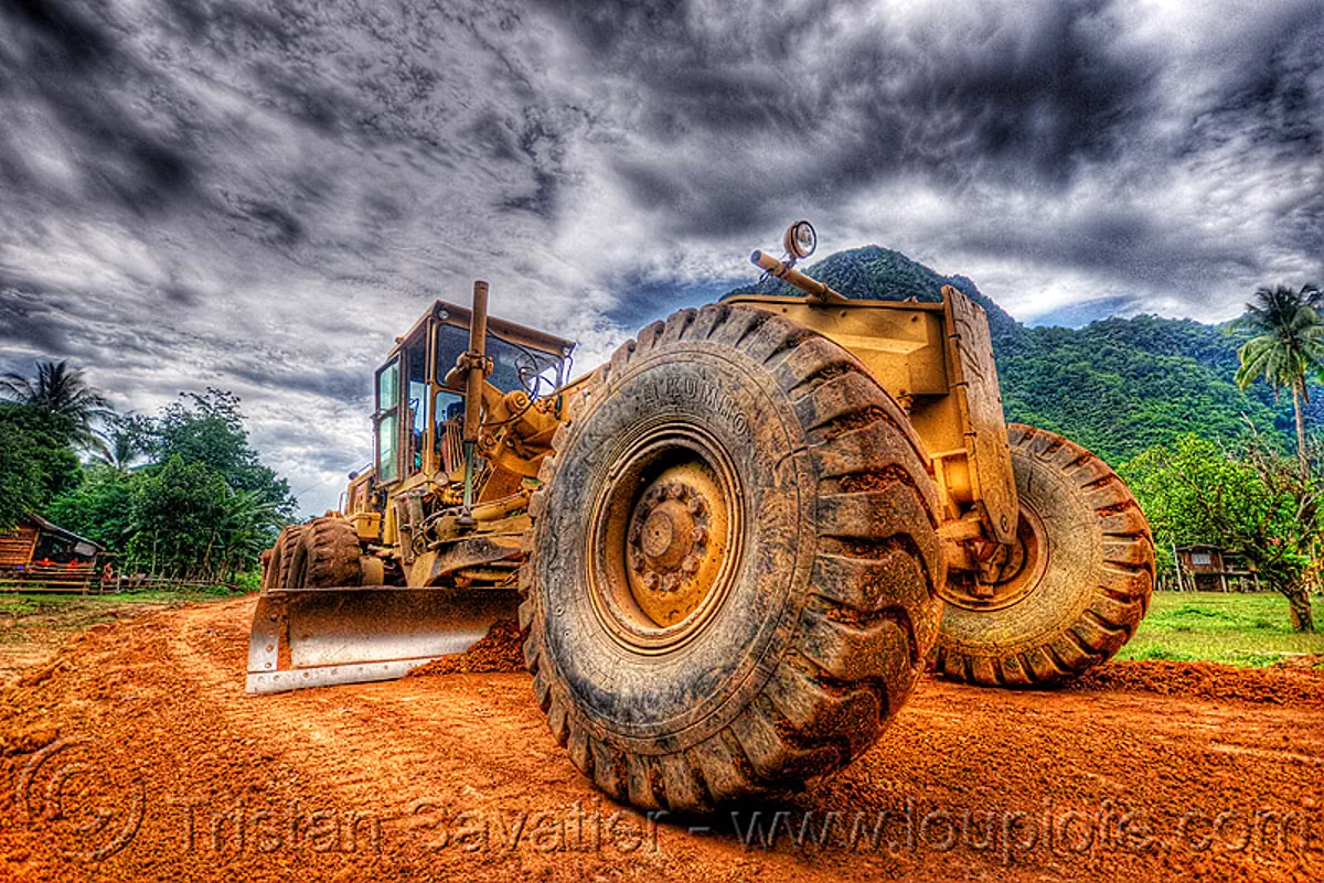 road grader - caterpillar CAT 14G (140G), cat grader, caterpillar 140g, caterpillar 14g road grader, caterpillar road grader, groundworks, heavy equipment, hydraulic, machinery, motor grader, mud tires, road construction, roadworks, wheels, yellow, stock photo