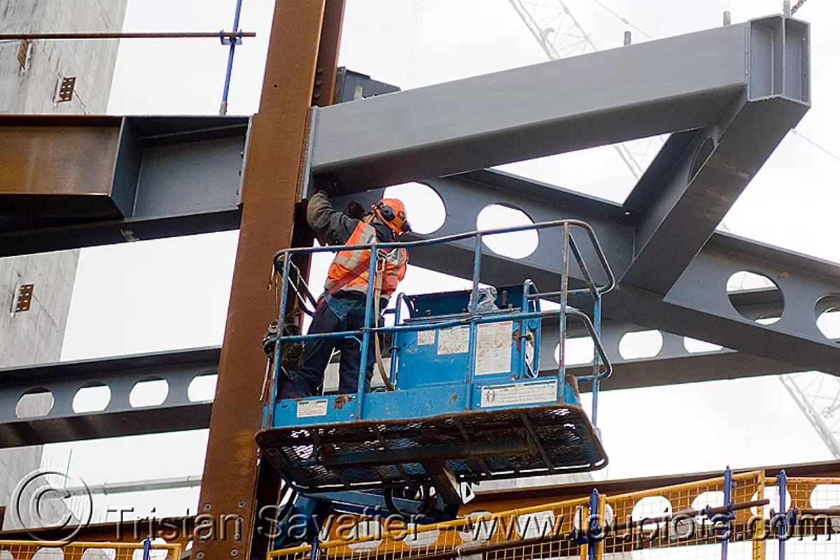 steel frame building construction - steel beams - the walbrook (london), aerial lift, boom lift, cherry picker, construction worker, crane, hydraulic, reflective vest, safety harness, safety helmet, stock photo