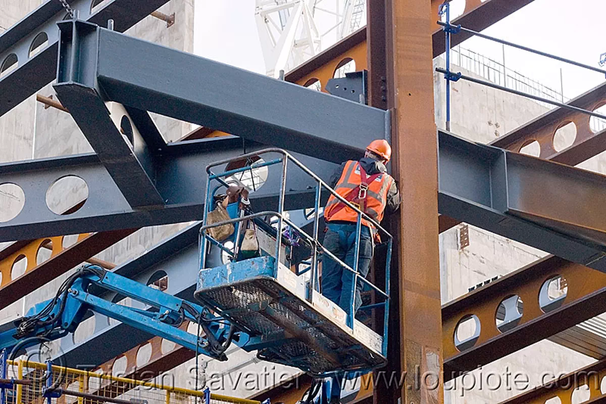 steel frame building construction - steel beams - the walbrook (london), aerial lift, boom lift, cherry picker, construction worker, crane, hydraulic, reflective vest, safety harness, safety helmet, stock photo