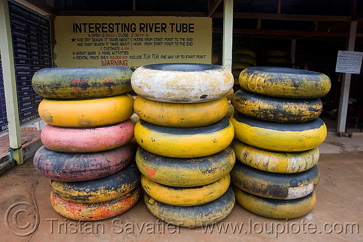 river tubing in vang vieng (laos), inner tubes, stacked, stacks, yellow, stock photo