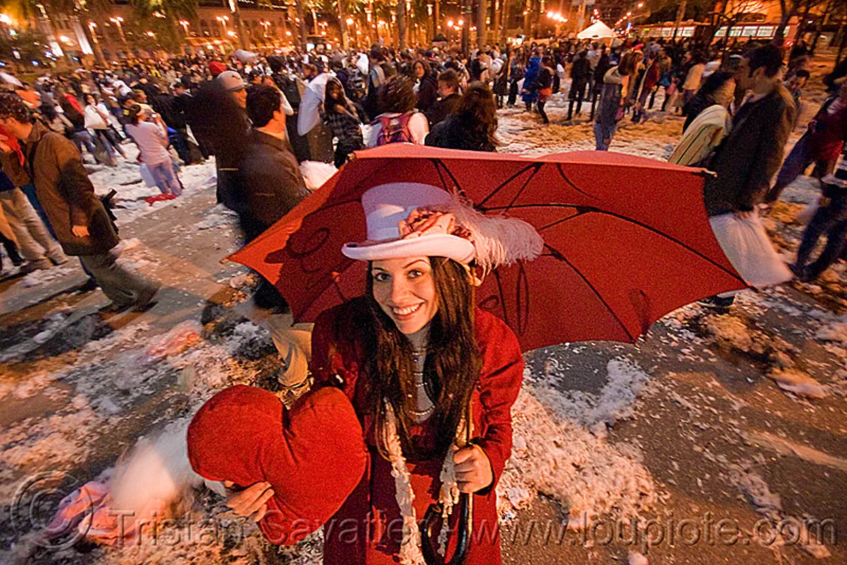 A woman with a heart - diana furka - the great san francisco pillow fight 2009, down feathers, heart pillow, night, pillow fight club, pillows, red color, red umbrella, world pillow fight day, stock photo