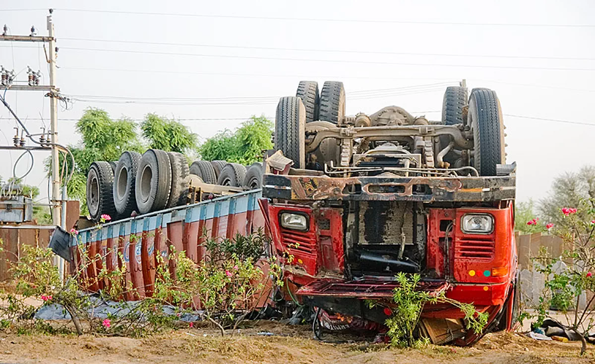 overturned big rig - truck accident (india), artic, articulated lorry, collision, overturned truck, road crash, semi truck, semi-trailer, tata motors, tractor trailer, traffic accident, traffic crash, up side down, wreck, stock photo