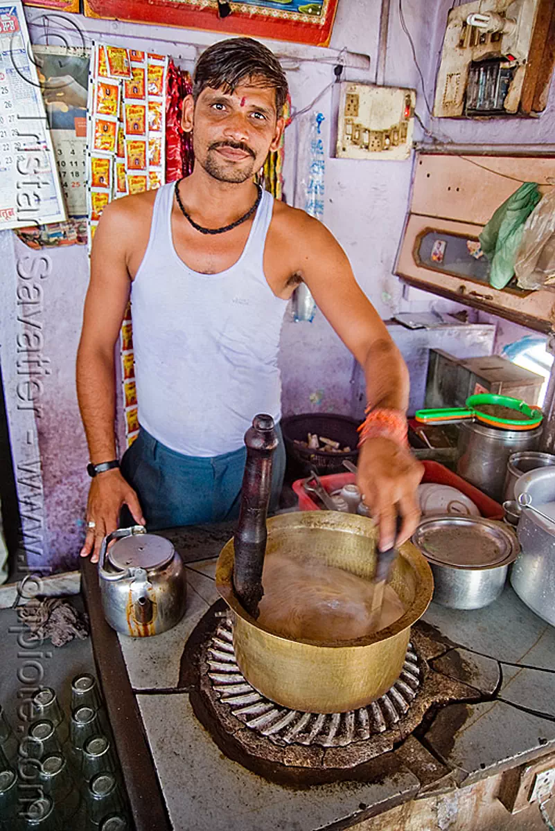 man making chai - sailana (india), chai wallah, copper pot, stove top, stock photo