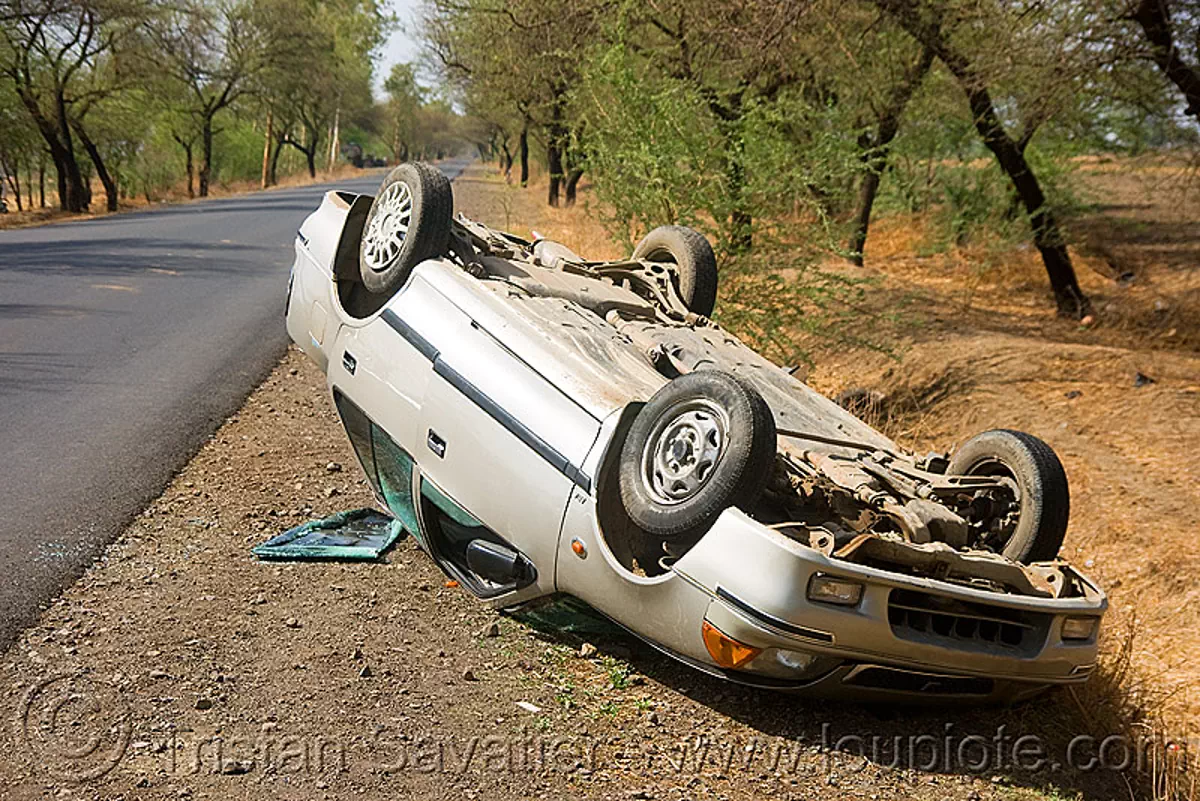 overturned car in ditch, crash, road, traffic accident, up side down, wreck, stock photo