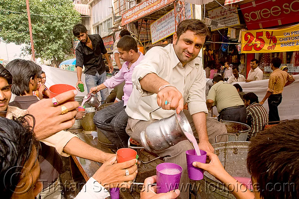 free pink drinks - hindu holiday - delhi (india), free drinks, hands, jar, pitcher, plastic cups, pouring, street, water, stock photo