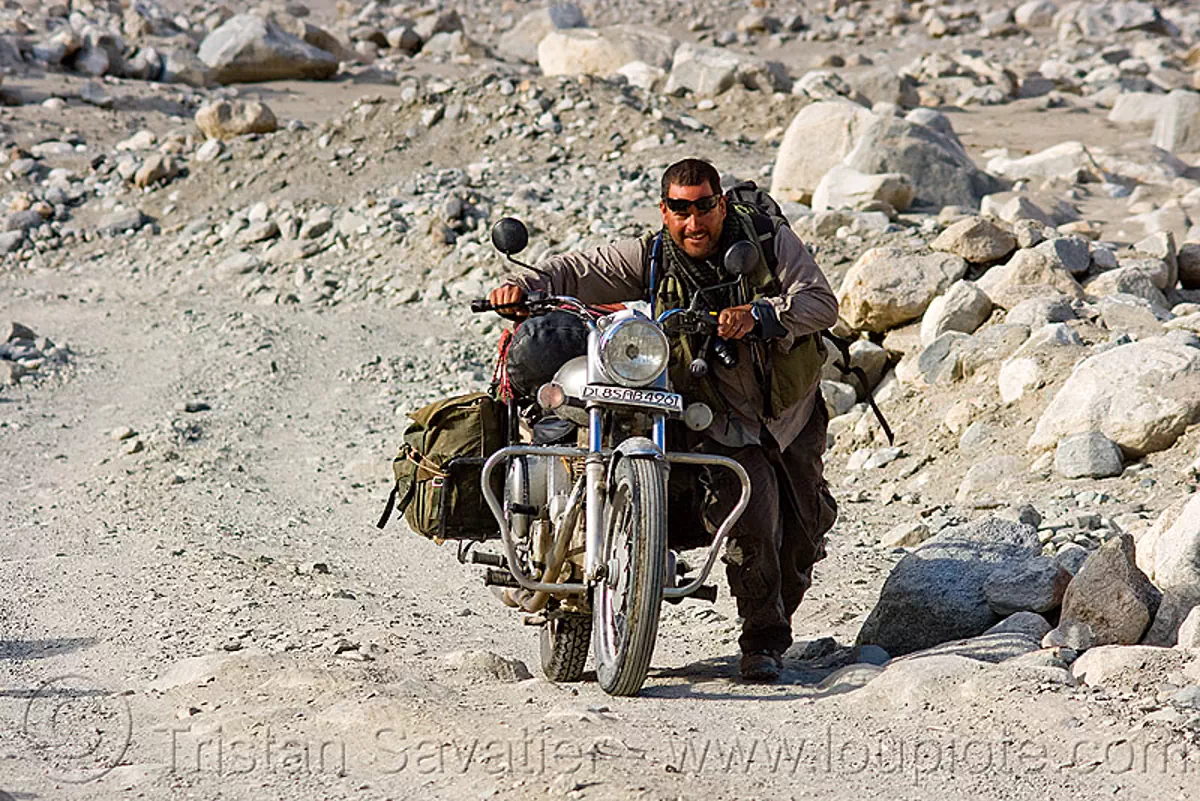 ben pushing his royal enfield motorcycle - road to pangong lake - ladakh (india), 350cc, motorbike, royal enfield bullet, stock photo