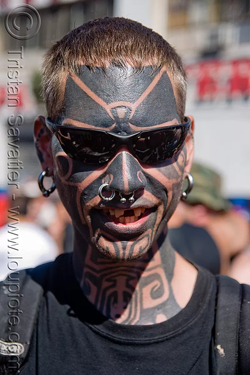 face tattoo, dore alley fair, earrings, full face tattoo, man, nose piercing, nose ring, nostril piercing, septum piercing, sunglasses, tattooed, stock photo