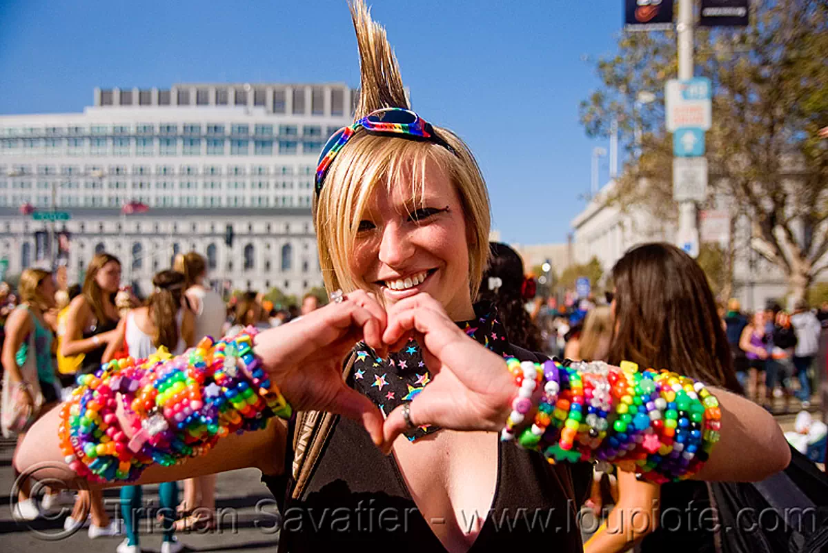 kandi kid with mohawk making a heart, beads, bracelets, festival, goggles, jennifer, kandi cuffs, kandi raver, love fest, lovevolution, mohawk hair, plur, stock photo