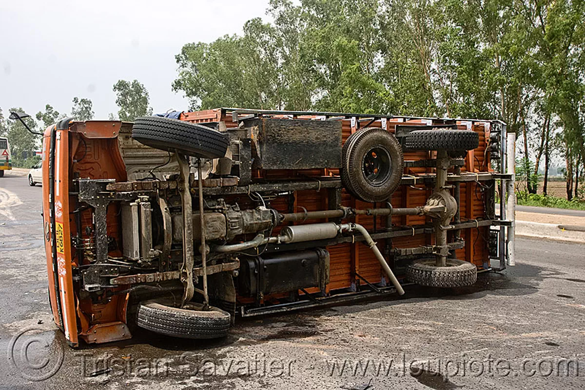 overturned truck - eicher motors (india), crash, lorry, road, traffic accident, truck accident, wreck, stock photo