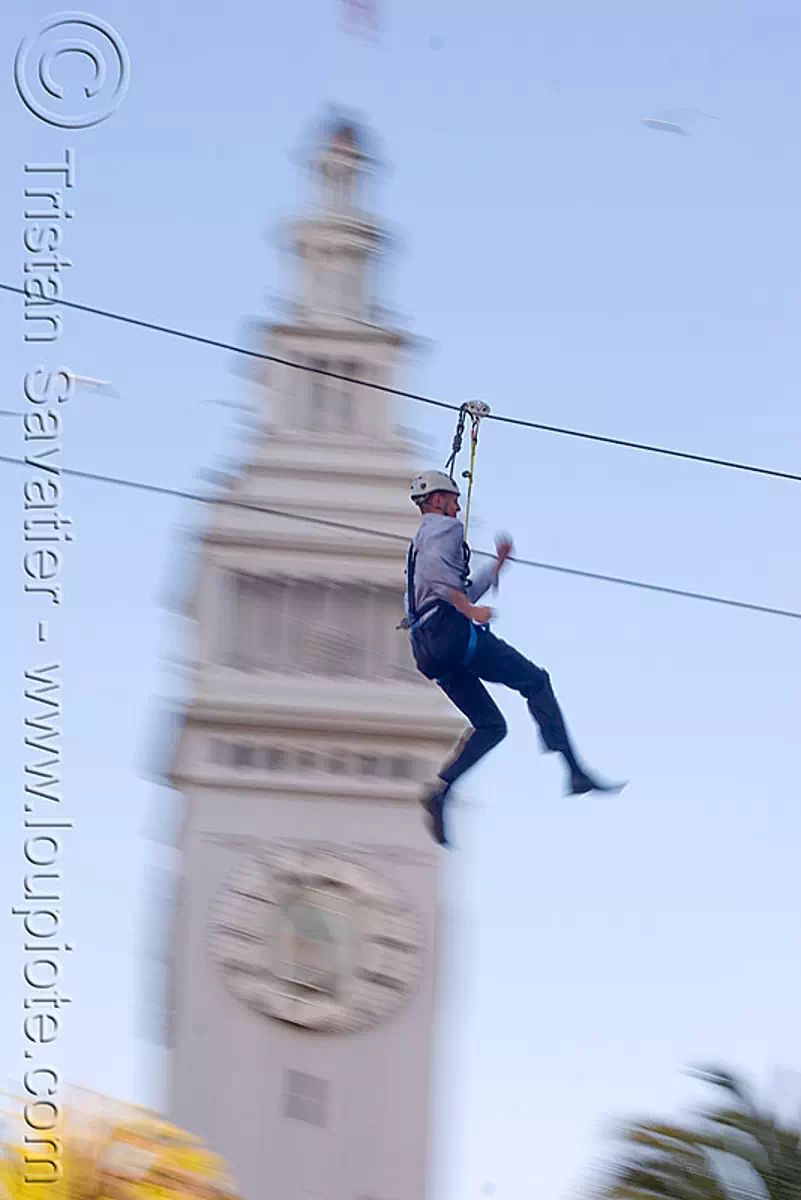 zip-line over san francisco, adventure, blue sky, cable line, cables, campanil, climbing helmet, clock tower, embarcadero tower, extreme sport, fast, ferry building, gear, hanging, harness, justin herman plaza, mountaineering, moving, speed, steel cable, trolley, tyrolienne, urban, zip line, ziptrek, stock photo