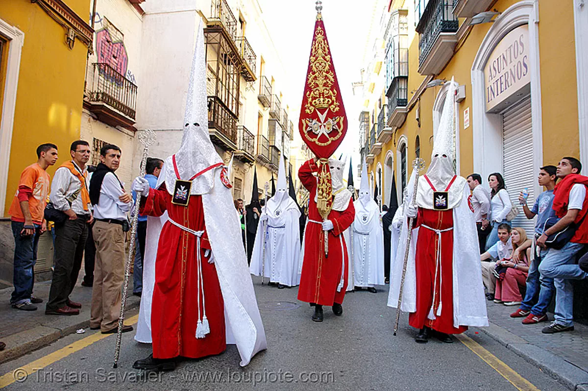 unidentified hermandad - semana santa en sevilla, andaluc&iacute;a, capirotes, cofrad&iacute;a, easter, espa&ntilde;a, nazarenos, parade, procesi&oacute;n, procession, red, religion, spain, stock photo