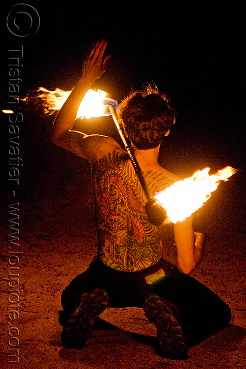 fire performer spinning fire staff - back tattoo  (san francisco), back piece, fire dancer, fire dancing, fire spinning, flame, man, night, tattooed, vin deluca, stock photo