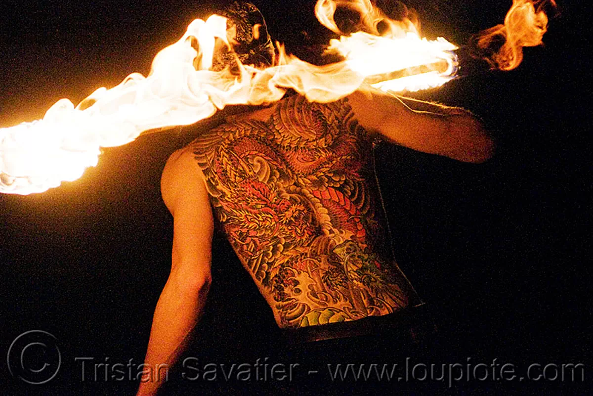 fire performer spinning fire staff - back tattoo (san francisco), back piece, fire dancer, fire dancing, fire spinning, flame, man, night, tattooed, vin deluca, stock photo