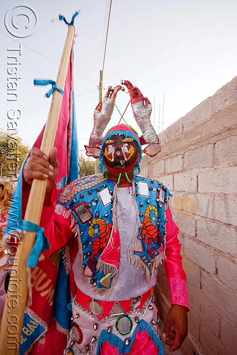 diablo near wall - carnaval de humahuaca (argentina), carnival, comparsa, costume, diablo carnavalero, diablo de carnaval, flag, folklore, horns, los picaflores, man, mask, mirrors, noroeste argentino, quebrada de humahuaca, tribal, stock photo