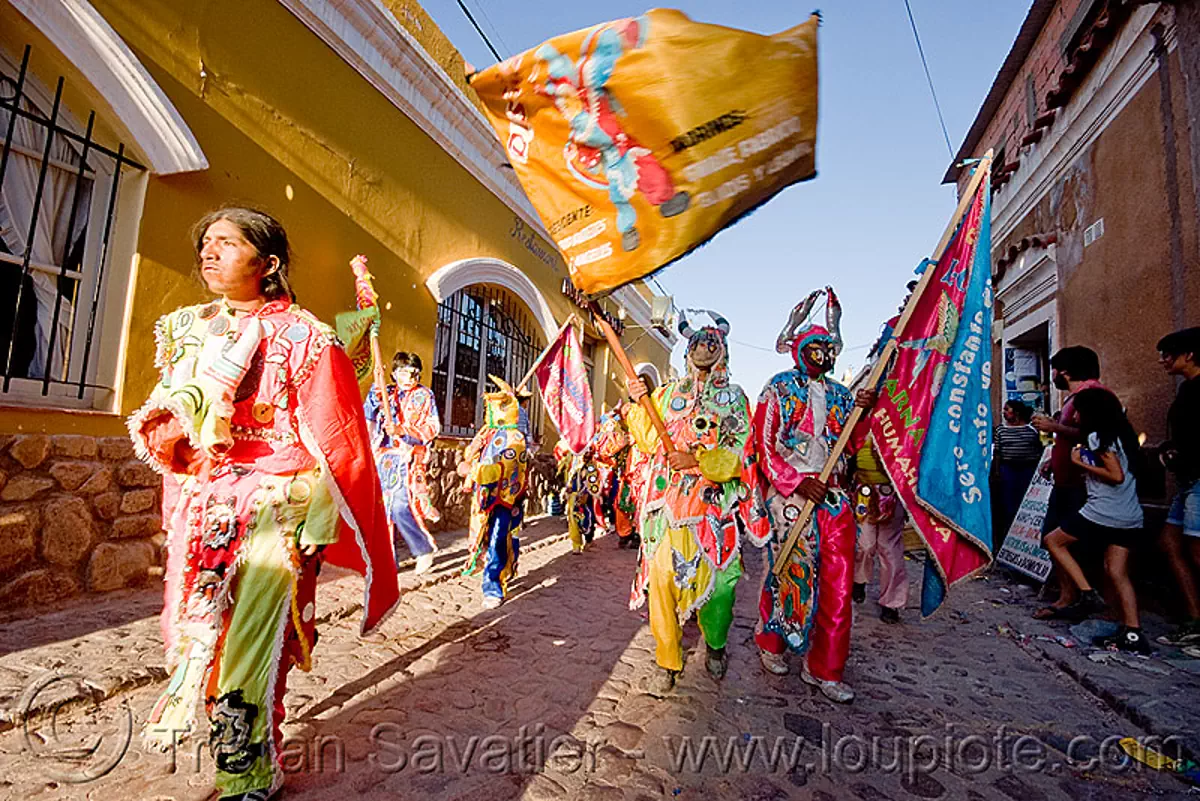 comparsa los picaflores - diablos carnavaleros - carnaval de humahuaca (argentina), carnival, costume, diablo carnavalero, diablo de carnaval, flag, folklore, horns, man, mask, mirrors, noroeste argentino, quebrada de humahuaca, tribal, stock photo