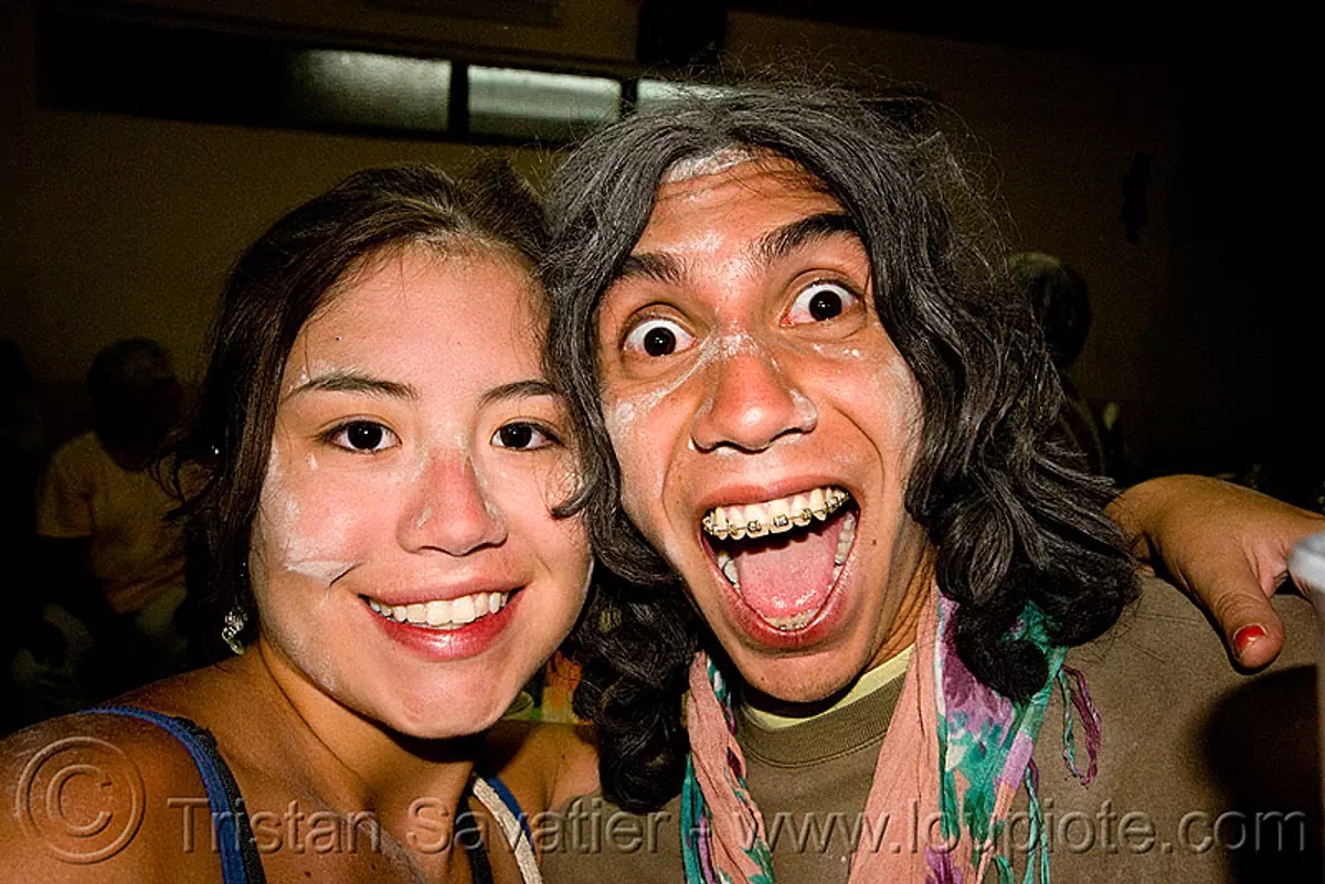 couple enjoying the carnaval de humahuaca (argentina), asian woman, carnival, dental braces, drunk, man, noroeste argentino, orthodontic braces, quebrada de humahuaca, talk powder, teeth, stock photo