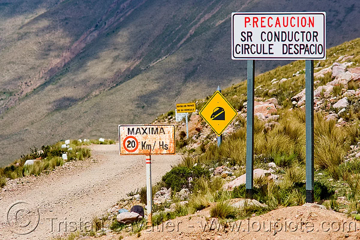 ominous road signs, danger, dirt road, iruya, mountain pass, mountains, noroeste argentino, quebrada de humahuaca, traffic sign, stock photo