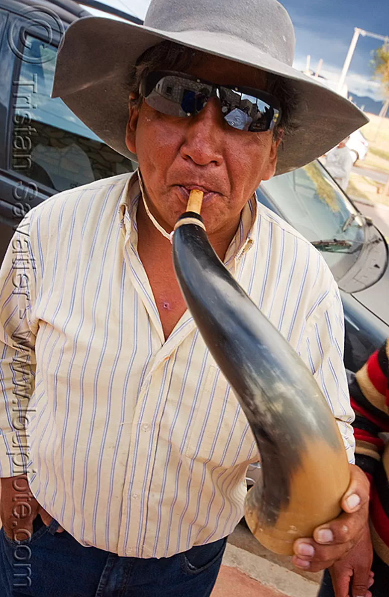gaucho playing cow horn, abra pampa, carnaval, carnival, folklore, hat, horn player, man, music, noroeste argentino, old, quebrada de humahuaca, stock photo
