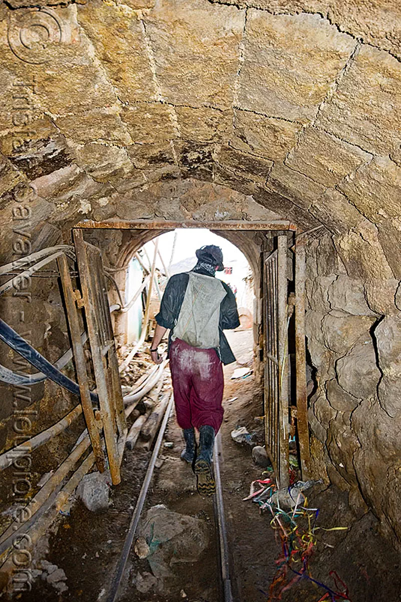 mine tunnel - bocamina - entrance, cerro rico, door, gate, grid, man, masonry, mina candelaria, mine worker, miner, mining, potos&iacute;, rails, safety helmet, vault, stock photo