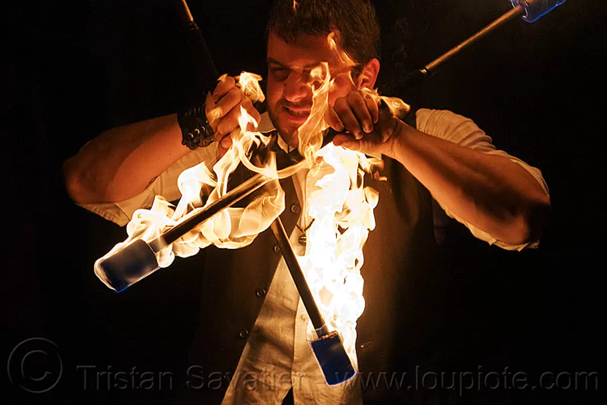eric spinning fire staves, fire dancer, fire dancing, fire performer, fire spinning, fire staffs, flame, labyrinth under the mask, man, night, stock photo