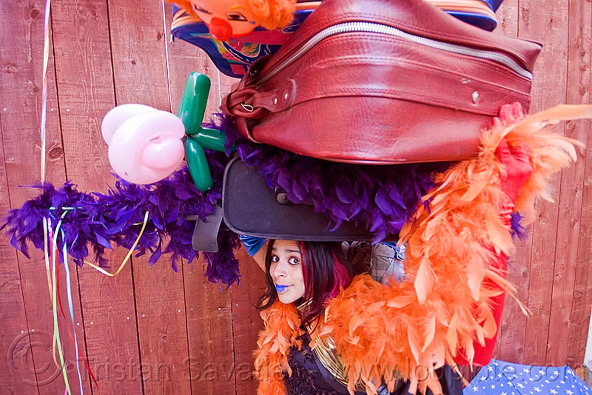 clown act, blue lipstick, circus artist, feather boa, luggage, mumu, party balloons, performer, props, suitcases, stock photo