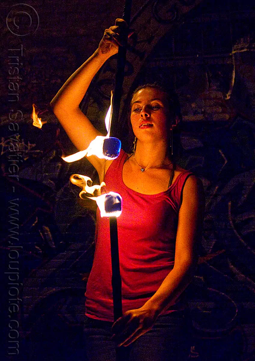 savanna spinning fire staffs, aligned, double staff, fire dancer, fire dancing, fire performer, fire spinning, fire staves, flame, night, stock photo