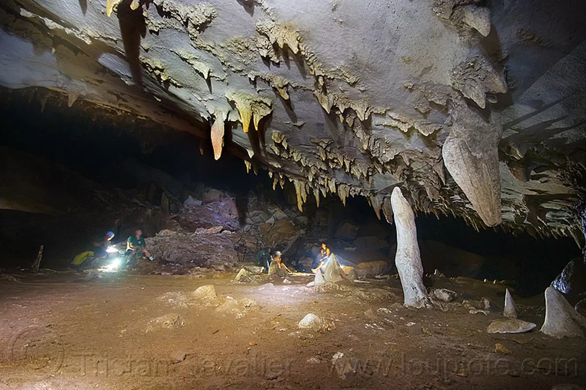 large underground chamber - caving in mulu - clearwater cave (borneo), cave formations, cavers, clearwater cave system, clearwater connection, concretions, gunung mulu national park, natural cave, roland, speleothems, spelunkers, spelunking, stalactites, stalagmites, stock photo